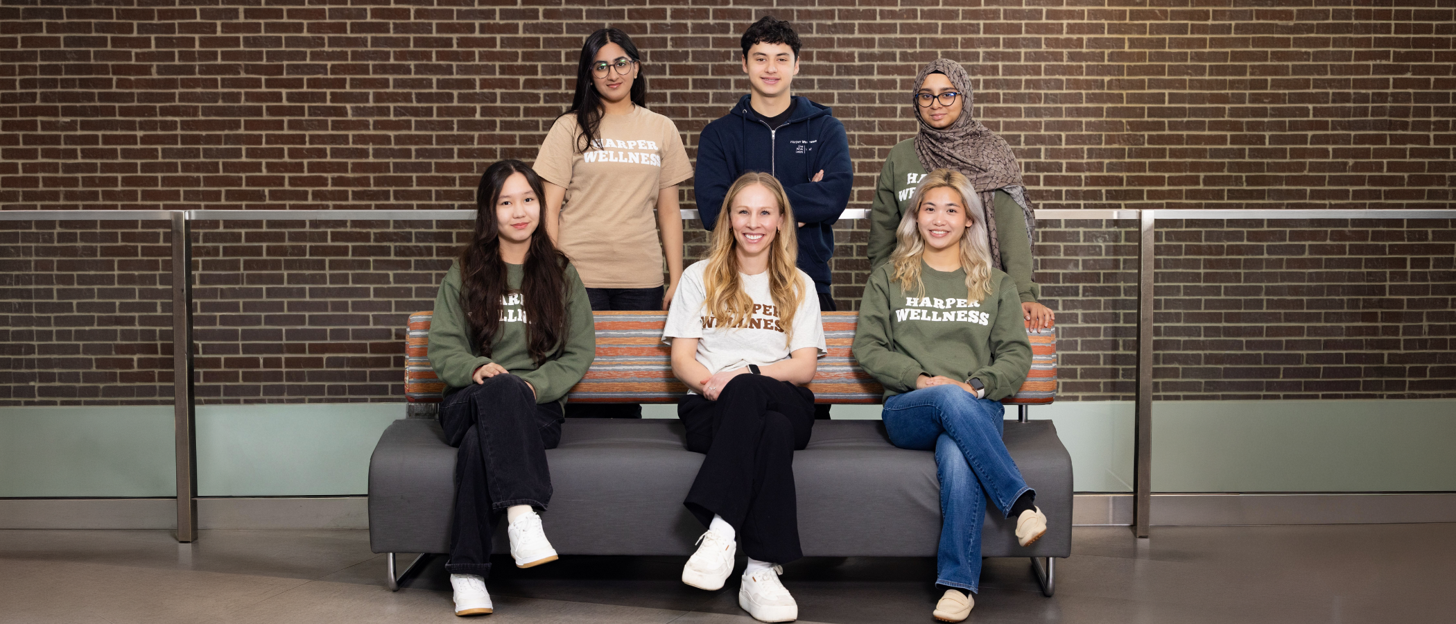 Group photo of wellness team, smiling, wearing matching Harper Wellness sweatshirts
